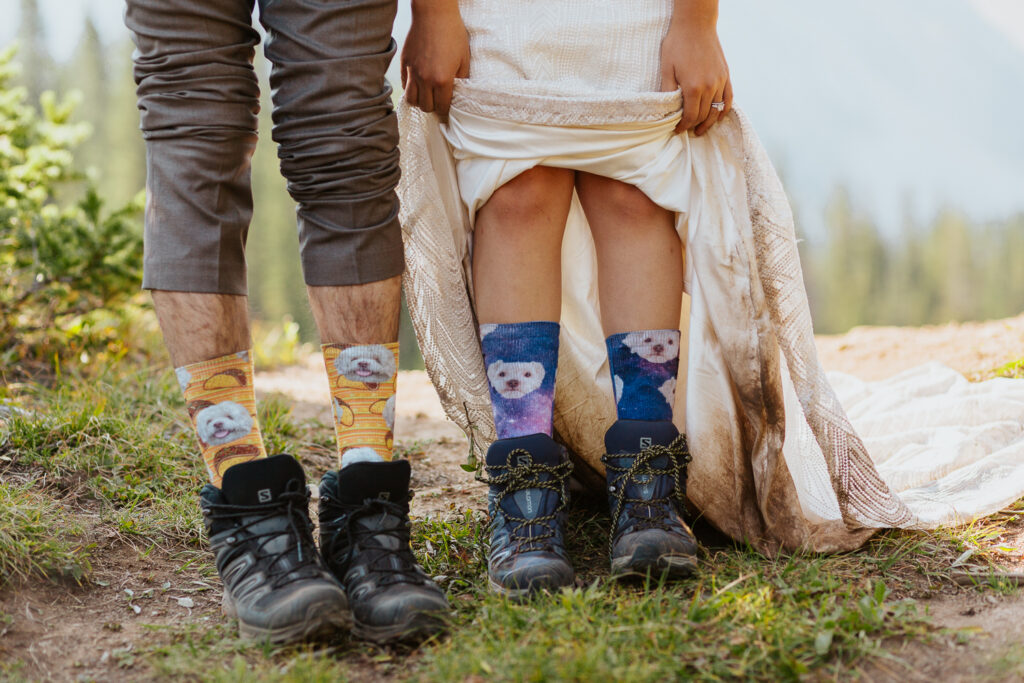 Anyeli and Alex proudly showing off their dog-themed socks during their adventure elopement in Crested Butte, Colorado.