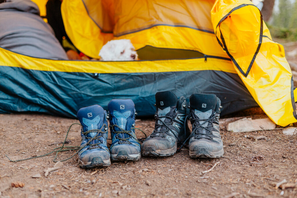 Hiking boots resting outside a tent in Crested Butte, Colorado, preparing for a sunrise elopement ceremony at Copper Lake.