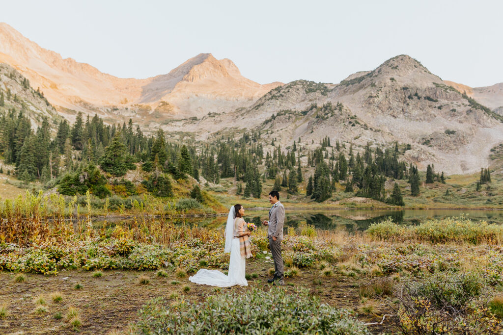 Anyeli and Alex exchanging heartfelt vows during their sunrise elopement ceremony at Copper Lake, Crested Butte, Colorado.