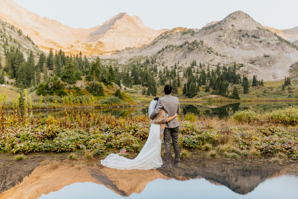 Anyeli and Alex sharing a loving hug after exchanging vows during their sunrise elopement ceremony at Copper Lake in Crested Butte, Colorado.