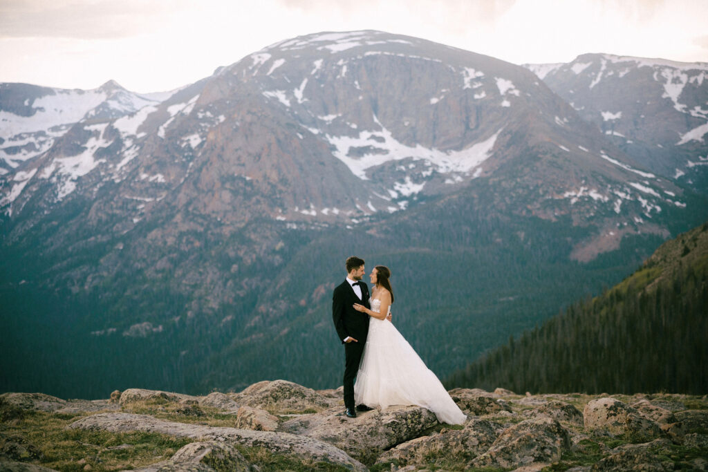 A couple poses for a portrait on Trail Ridge Road in Rocky Mountain National Park after their wedding day. 