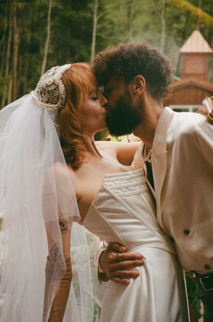 Film photo of the couple sharing a kiss outside their Leadville cabin during their intimate Colorado elopement.
