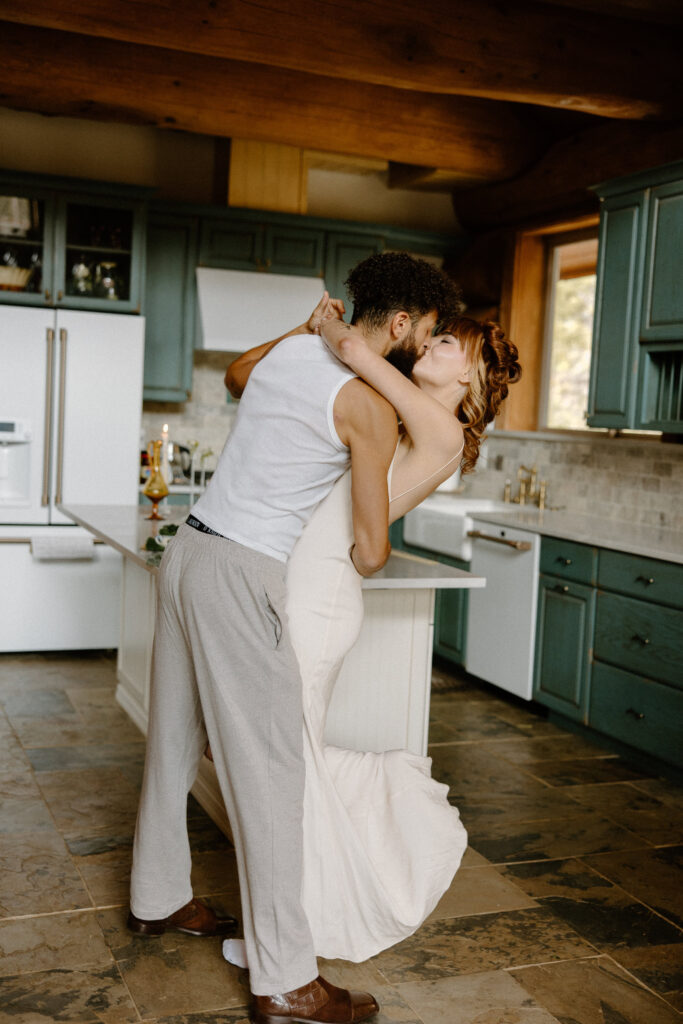Candid kiss between an adventurous couple inside their Colorado cabin on elopement day.