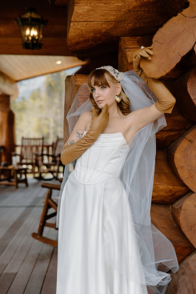 Colorado cabin elopement bride wearing a vintage 70s-inspired wedding dress for a romantic solo portrait.