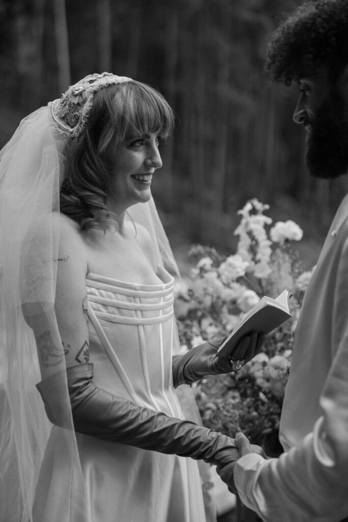 Candid vow exchange of a Colorado adventure elopement couple in a cozy cabin setting.
