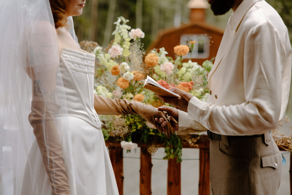 Romantic moment as the couple says their vows inside their rustic Colorado cabin.