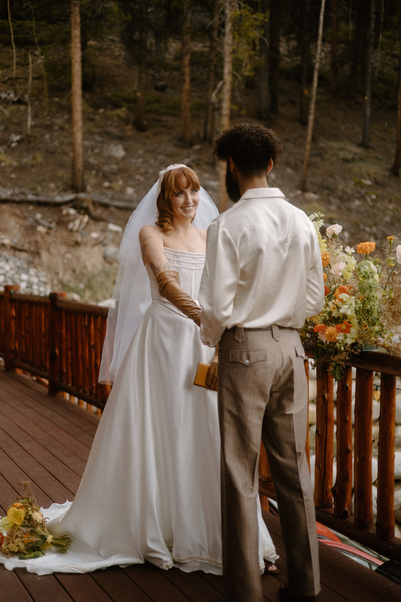 Adventure-loving couple exchanging personal vows during their cozy Colorado cabin elopement.