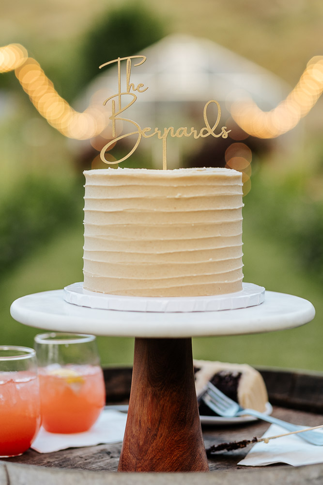 Elegant wedding cake placed in a flower garden at a beautiful Colorado venue.