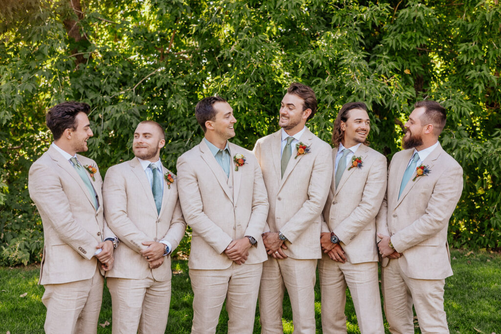 Groom and groomsmen share a joyful smile during the wedding celebration at their Colorado venue.