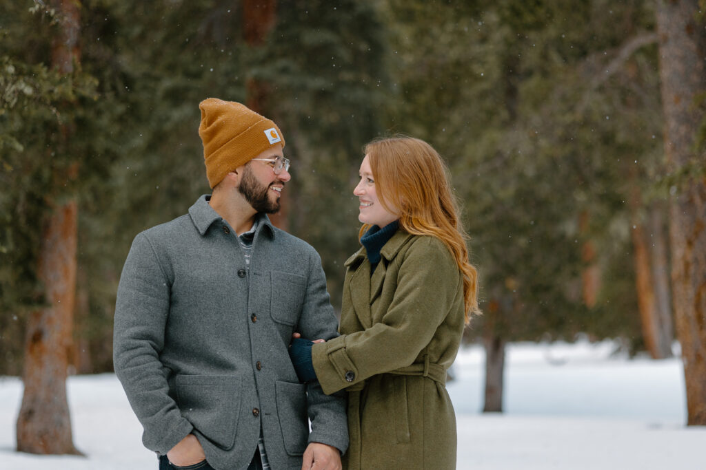 A bride holds on to her groom during their engagement session in Colorado.