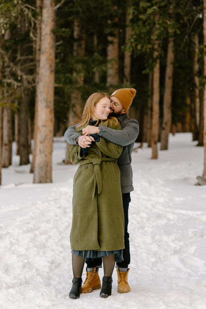 A couple embraces during their engagement session at Echo Lake.