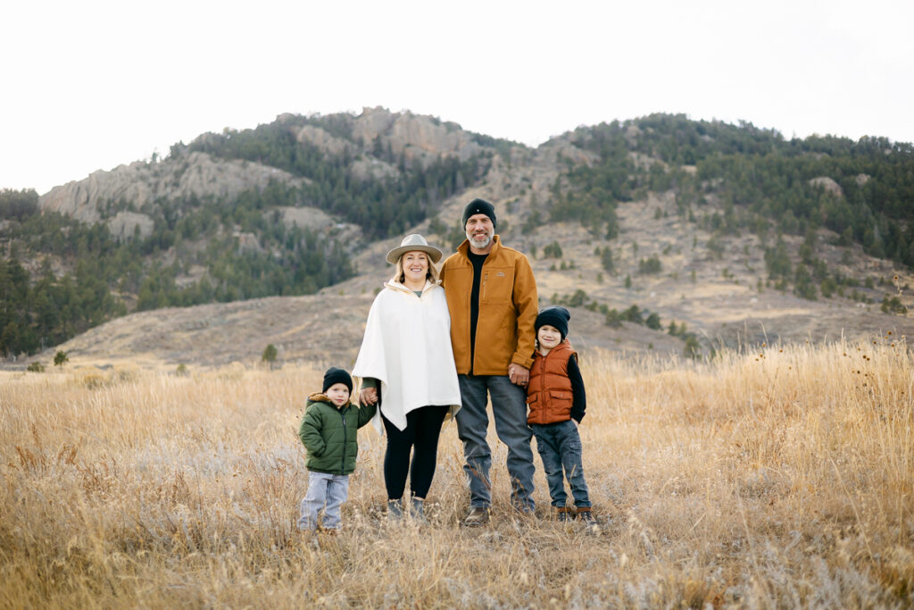 A family stands in front of the foothills during their family photos in Fort Collins, Colorado.