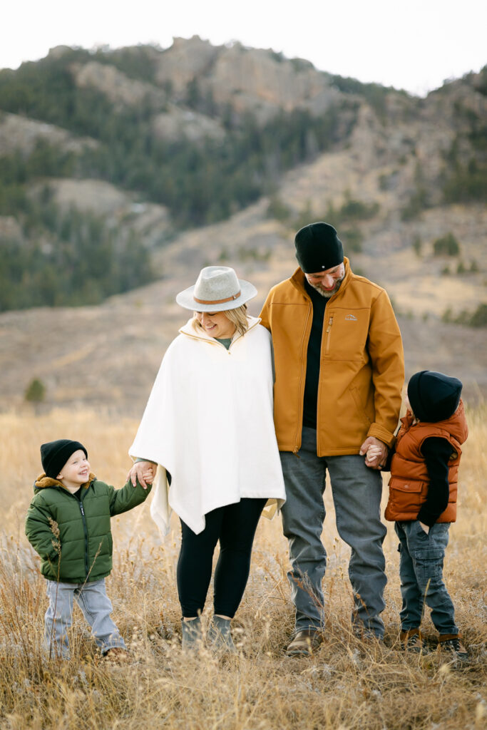 A family holds hands and poses for a photo in Lory State Park.