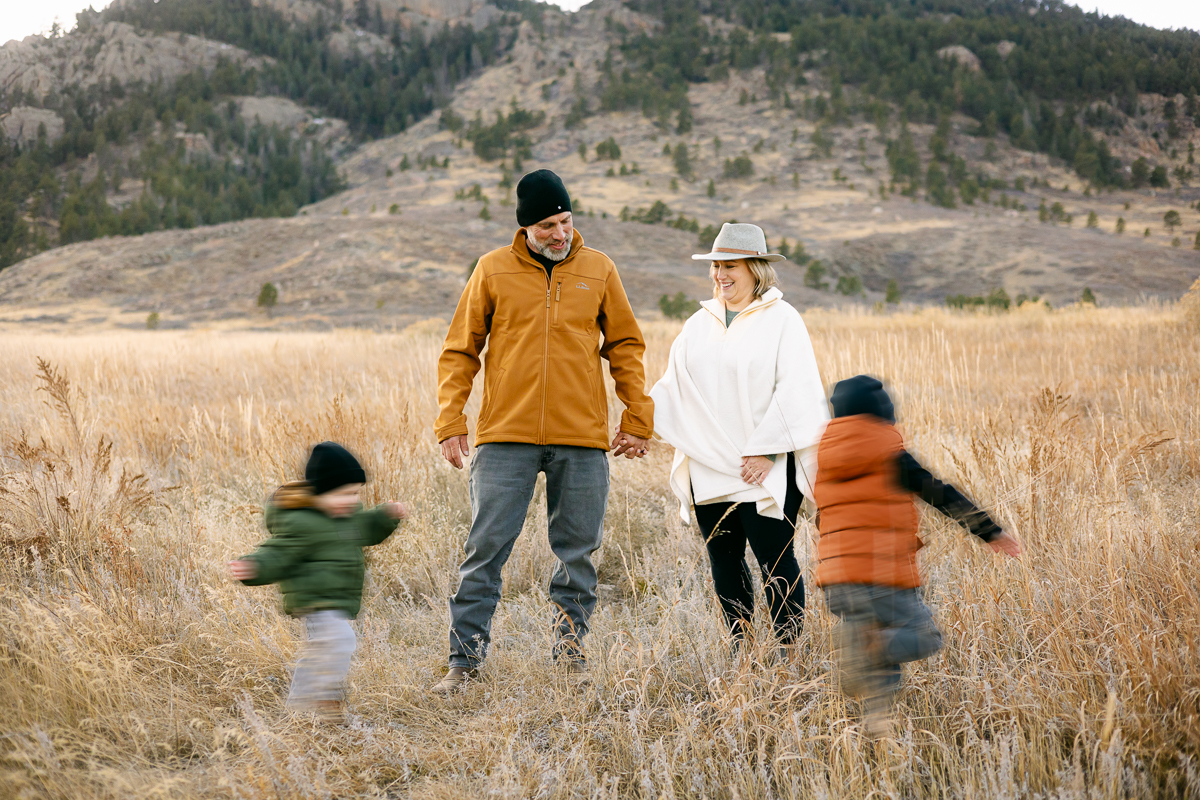 Parents watch as their boys run circles around them in Lory State Park, Colorado.